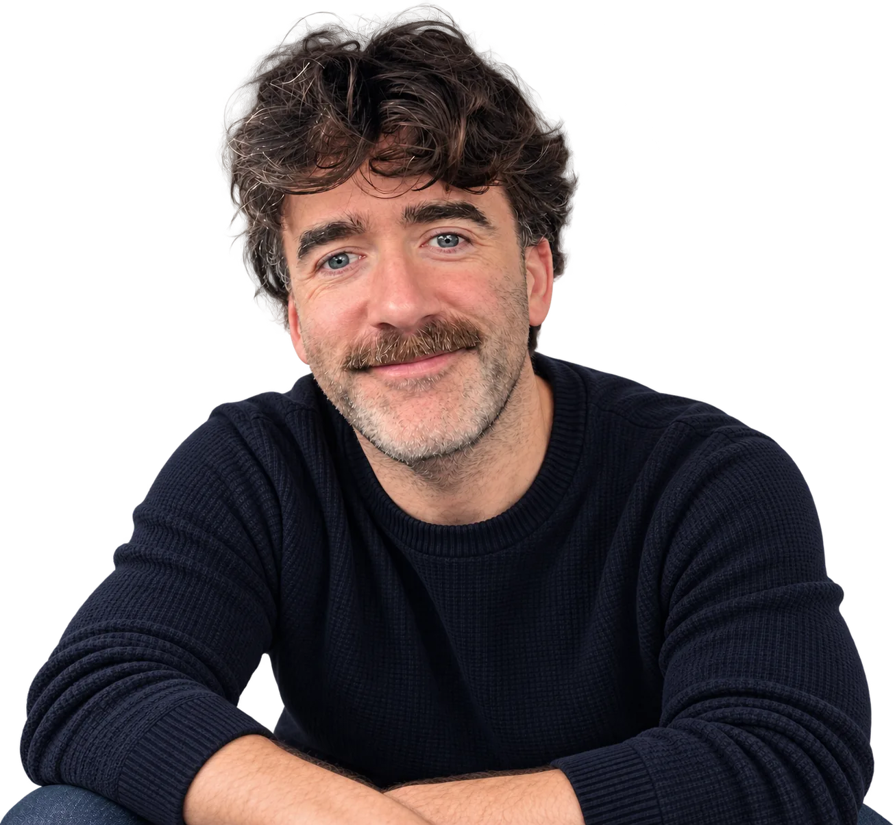 Drew McMaster, smiling, arms folded